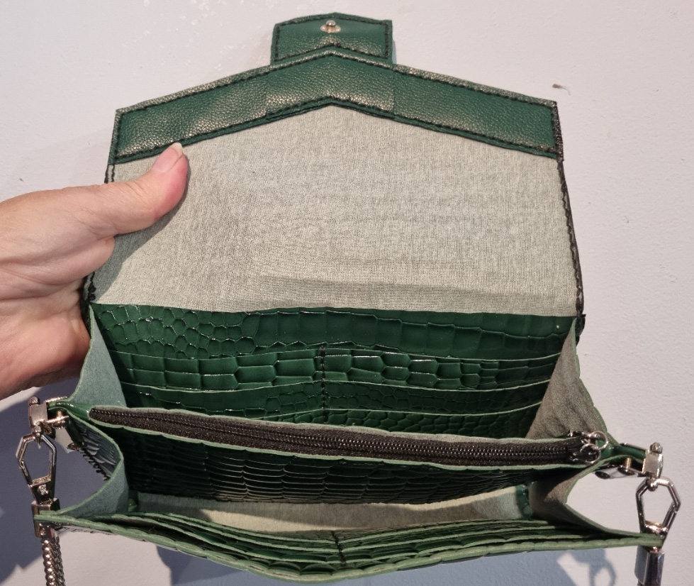Inside the green faux crocodile clutch purse