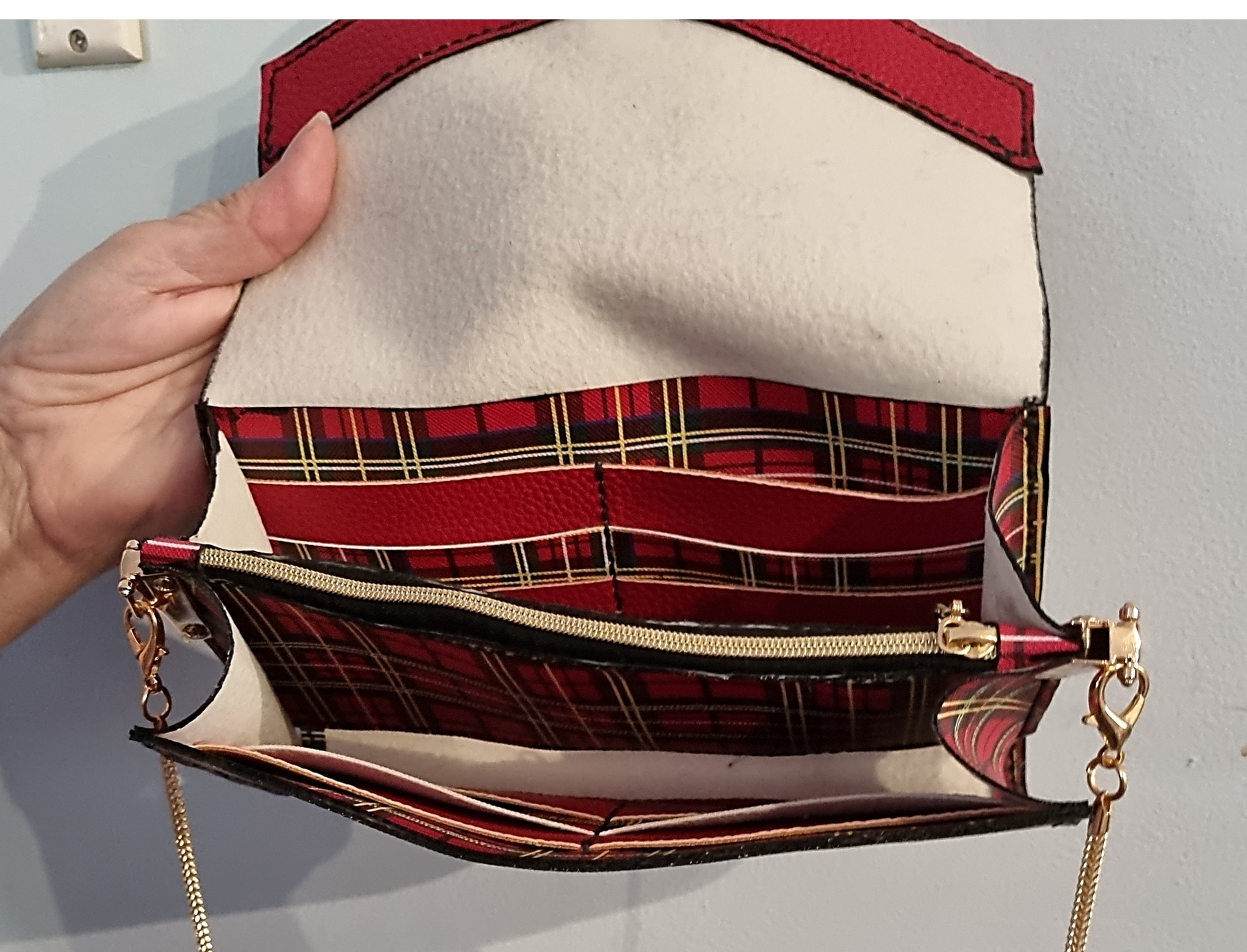 The roomy inside of the red and yellow tartan clutch bag